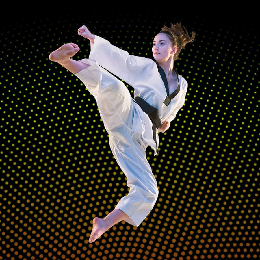 Martial Arts Lessons for Adults in Alpharetta GA - Girl Black Belt Jumping High Kick