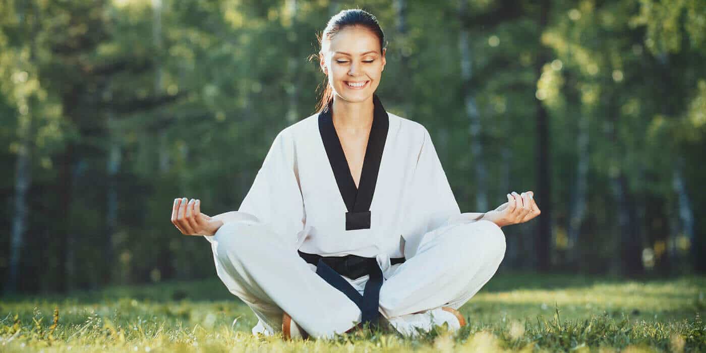 Martial Arts Lessons for Adults in Alpharetta GA - Happy Woman Meditated Sitting Background